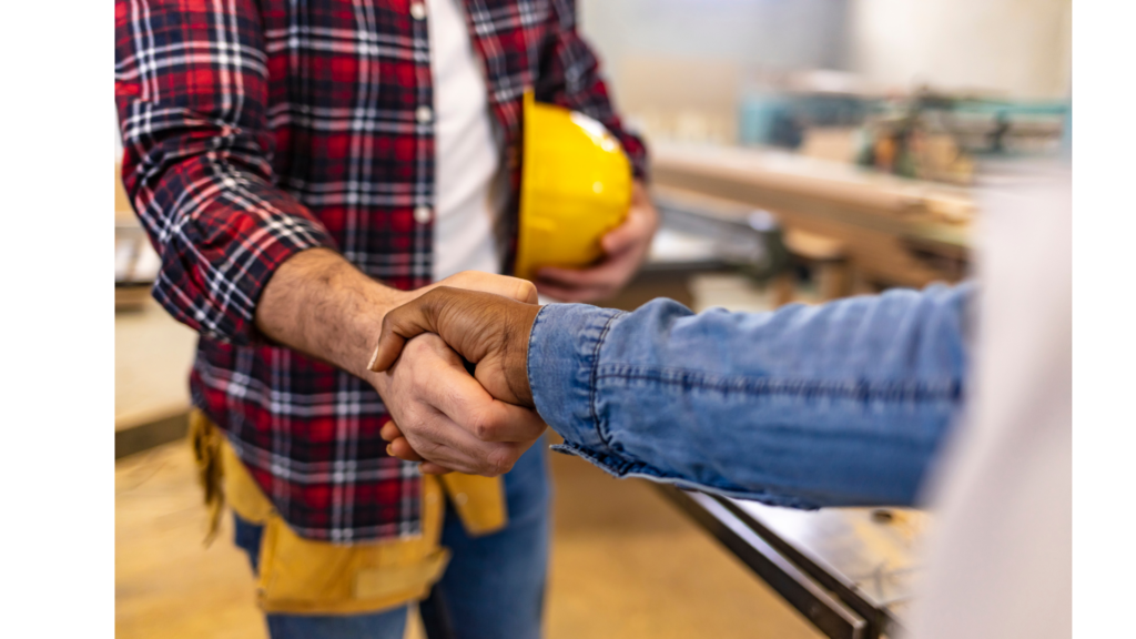 a homeowner shaking hands with a general contractor in a kitchen