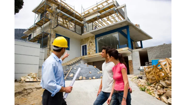 couple standing in front of a house being built discussing details with their contractor builder