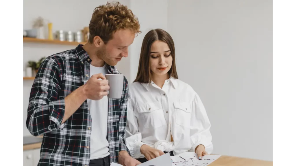 man and woman discussing details in paper documents