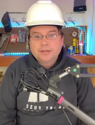 picture of David B in a hard hat with a microphone in front of him
